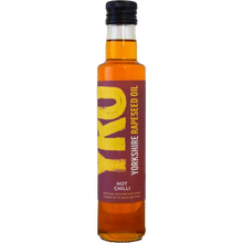 Load image into Gallery viewer, A bottle of Yorkshire Rapeseed Oil Hot Chilli flavor, showing the amber-colored oil inside a clear glass bottle with a dark purple label featuring yellow and white text, and a black cap.